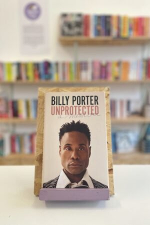 A copy of 'Unprotected' sits on a stand in front of multiple shelves of other books.