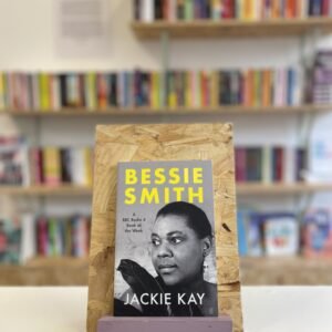 A copy of 'Bessie Smith' sits on a stand in front of multiple shelves of other books.