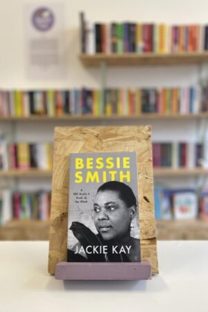 A copy of 'Bessie Smith' sits on a stand in front of multiple shelves of other books.