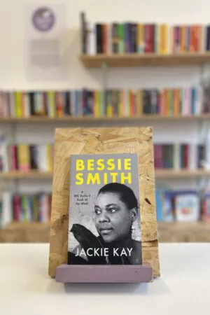 A copy of 'Bessie Smith' sits on a stand in front of multiple shelves of other books.