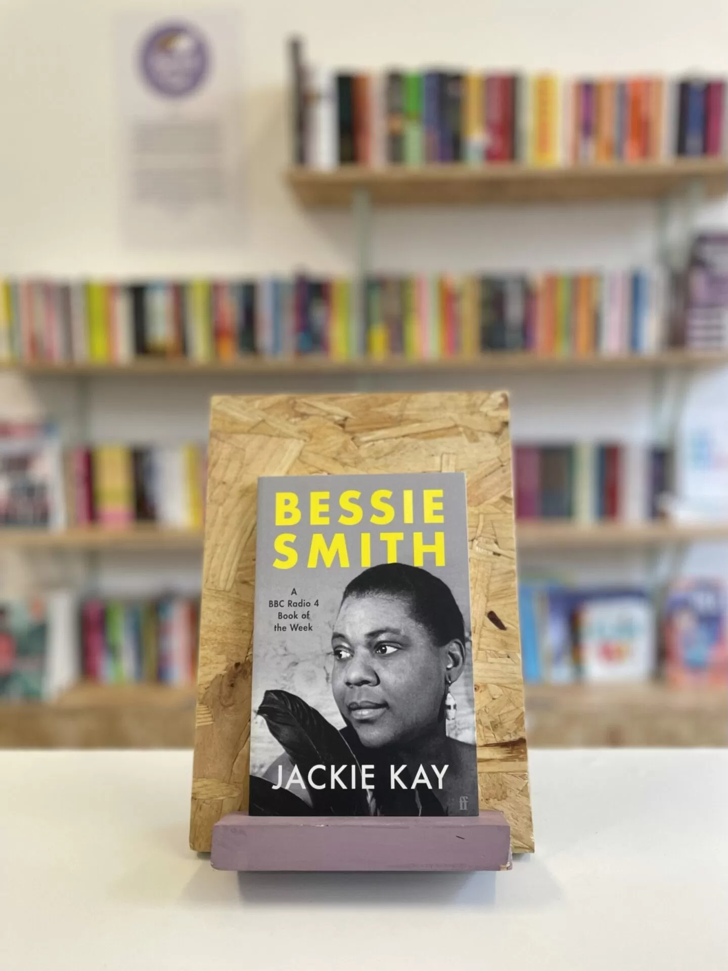 A copy of 'Bessie Smith' sits on a stand in front of multiple shelves of other books.