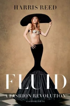 Cover of the book, featuring a model in a large black hat with red hair, a white bra and a long, black skirt with a mermaid cut.